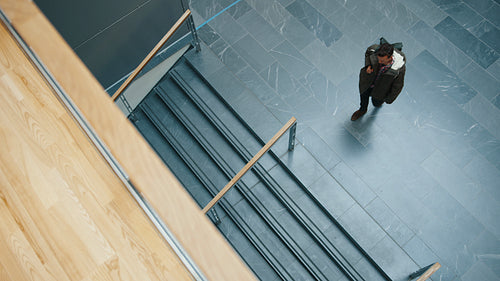 Going from one class to another, professors and students walk up and down on a college campus