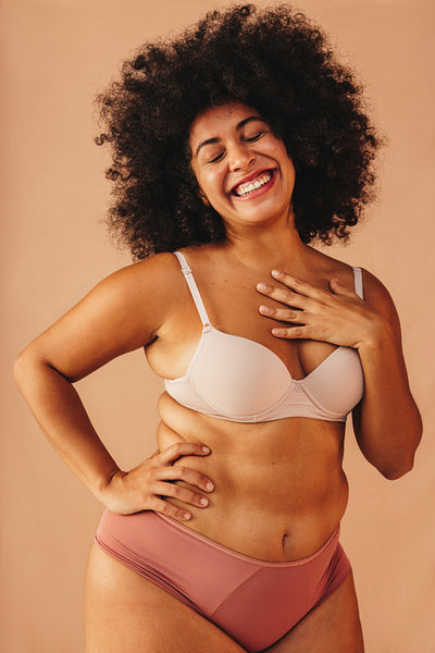 Body positive young woman smiling happily in underwear