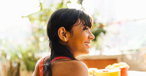Smiling young Latin American girl outdoors enjoying a sunny day