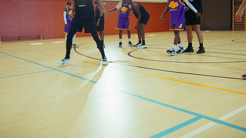 Young men playing basketball indoors