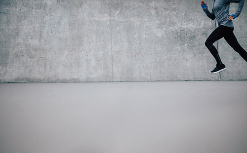 Athlete running on gray background