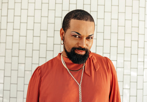Carefree drag queen looking at the camera against a white background