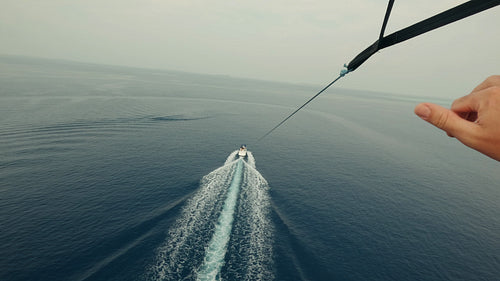 Parasailing high above the blue ocean