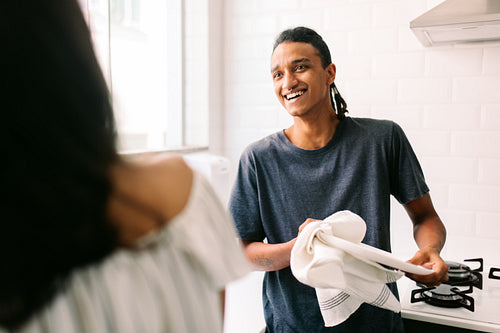 Couple doing the dishes together at home