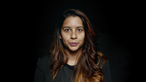Smiling businesswoman on black background