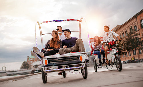 Young people enjoying tricycle ride in the city