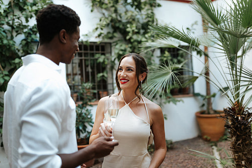 Interracial couple making a toast with sparkling wine