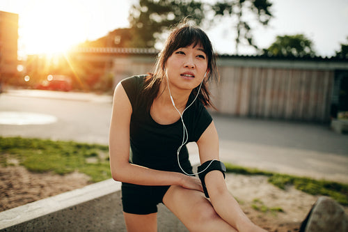 Female runner stretching legs before running workout