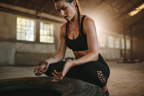 Muscular woman taking a break from cross training workout