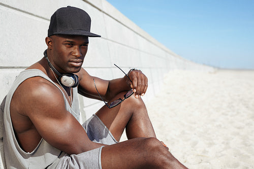 Young african man relaxing on the beach