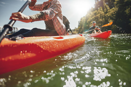 Couple canoeing in a lake on a summer day