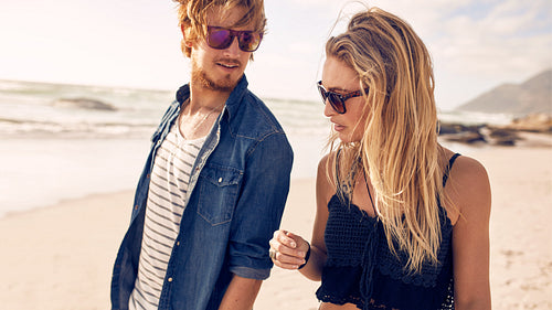 Young couple walking along a beach