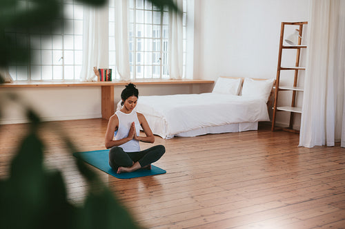 Beautiful young woman doing yoga exercise