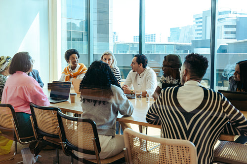 Diverse corporate team in a city office with a view of the urban skyline visible through large windows