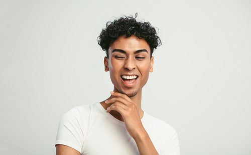 Gender fluid young man laughing