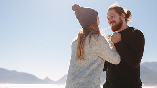Loving couple standing outdoors at the beach