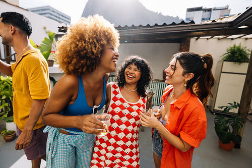 Group of friends enjoying a rooftop gathering in Rio de Janeiro