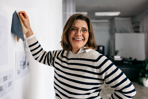 Design planning shows the furniture designer with fabric swatch ideas on the studio wall