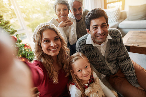 Happy extended family taking self portrait on christmas eve