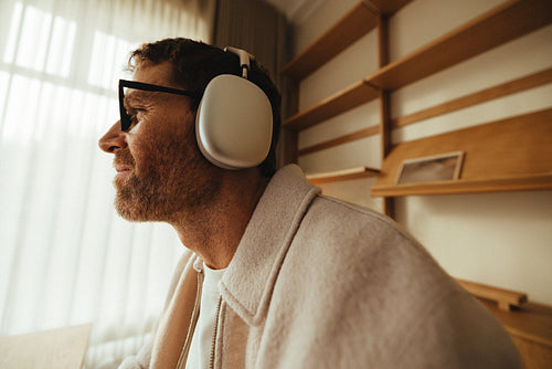 Focused professional working at screen with headphones