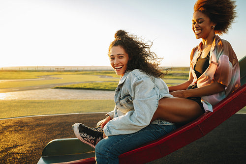 Teenage summer: Sunset in the park, laughing and sharing happiness together on a sunny day