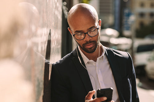 African businessman using mobile outside
