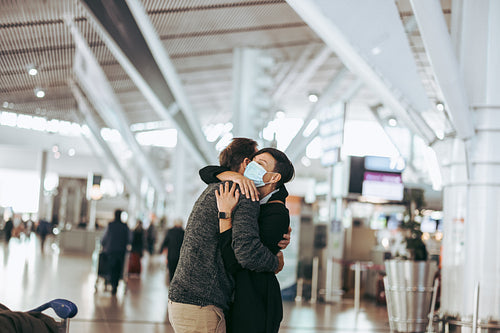 Woman welcoming man at airport