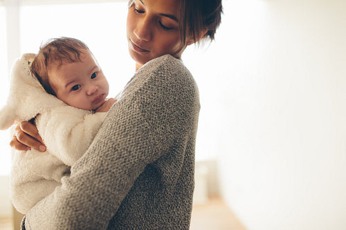 Mother carrying her newborn son