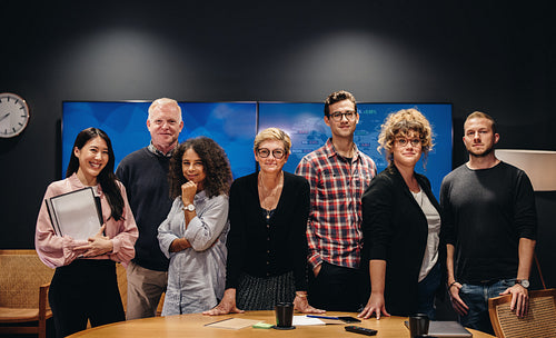 Team of reporters in boardroom