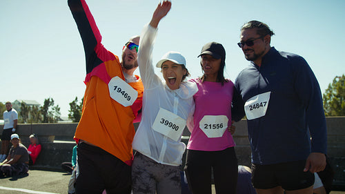 Happy runners celebrate their race achievement