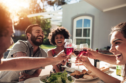 Young people raising their glasses for a toast