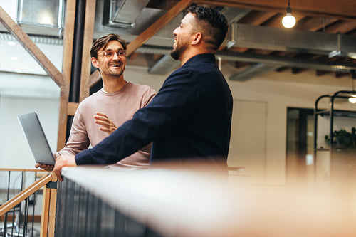 Male tech professionals having a discussion in an office