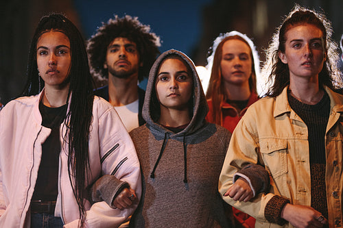 Activists marching together holding hands