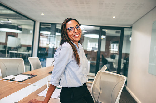 Mid-adult businesswoman smiling cheerfully in an office