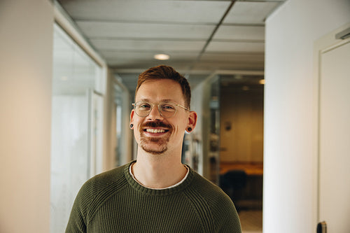 Portrait of happy male executive in office