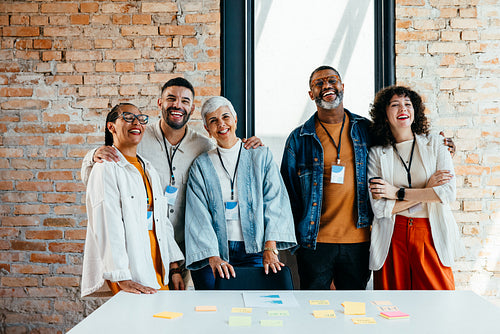 Diverse team of coworkers smiling confidently and standing together
