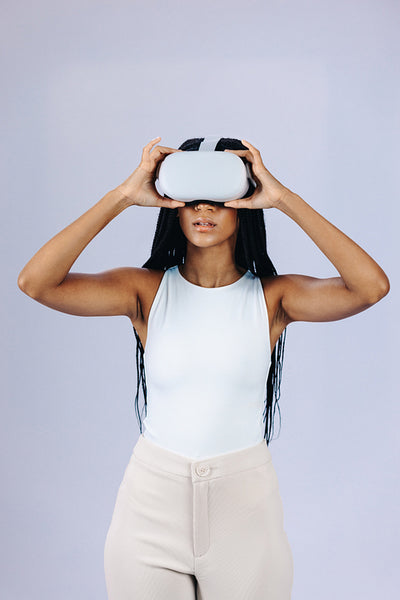 Young woman getting into the metaverse world using a vr headset