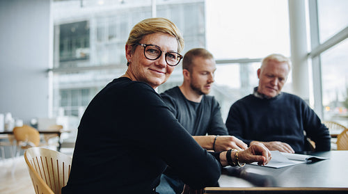 Happy senior businesswoman in boardroom meeting
