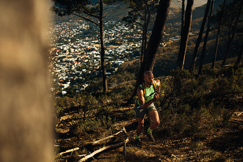 Fit sportsman sprinting over rocky trail