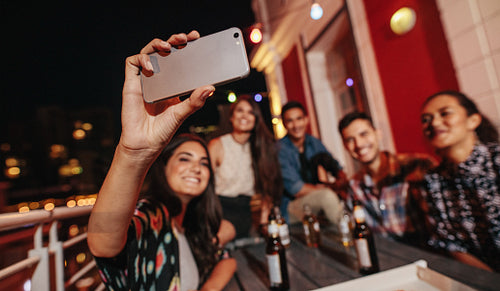 Young people taking self portrait during party