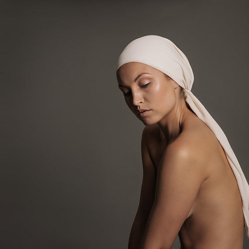 Young woman with naked body and head scarf