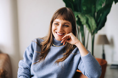 Thoughtful businesswoman smiling happily in an office