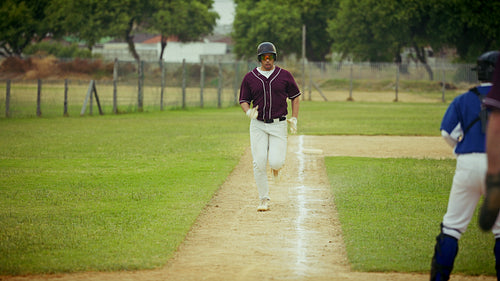 Baseball player slides into a base in action