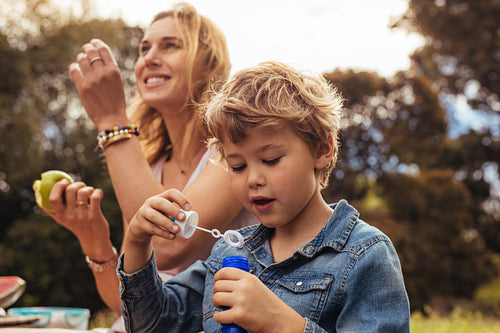 Small kid on picnic with his mother at the park
