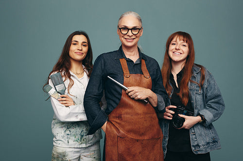 Women from different creative occupations smiling in a studio