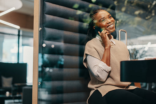 Black businesswoman working and communicating in a modern coworking office
