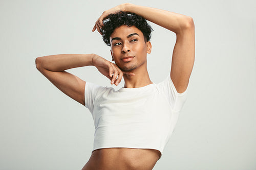 Gender fluid man posing on white background