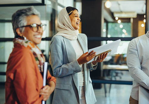 Successful businesspeople laughing happily during a meeting