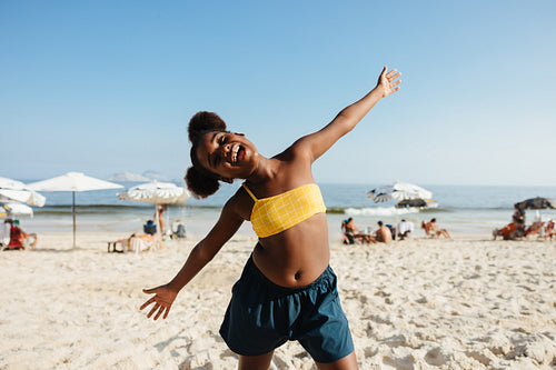 Joyful young girl enjoying a sunny day at the beach