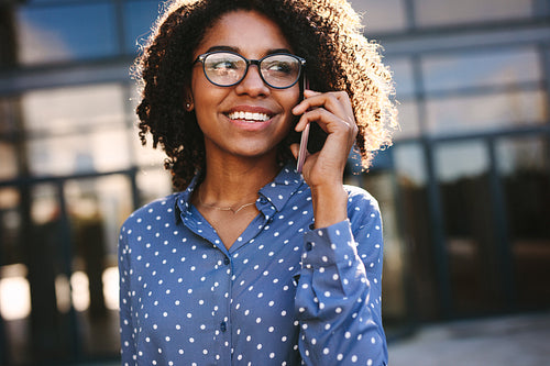 Businesswoman making a phone call outside